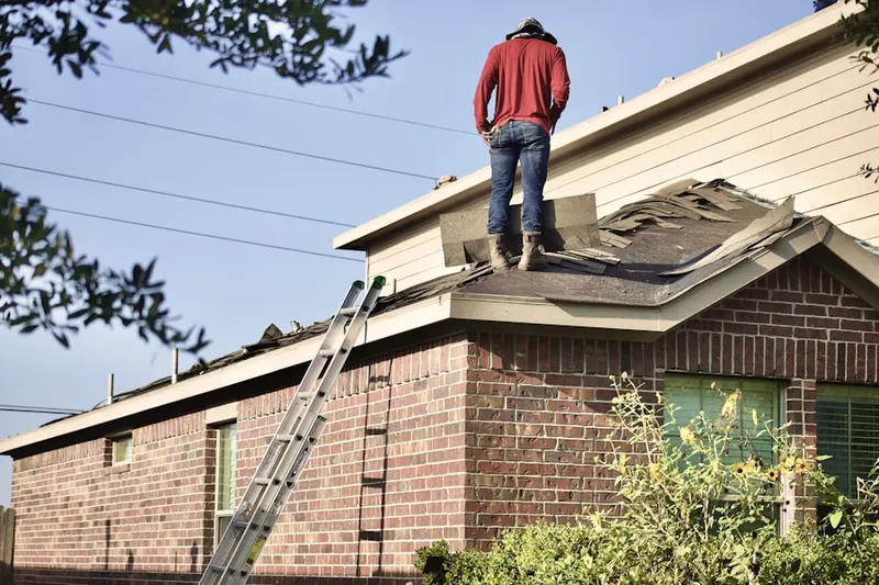 Professional roofer working on a residential roof in Longwood